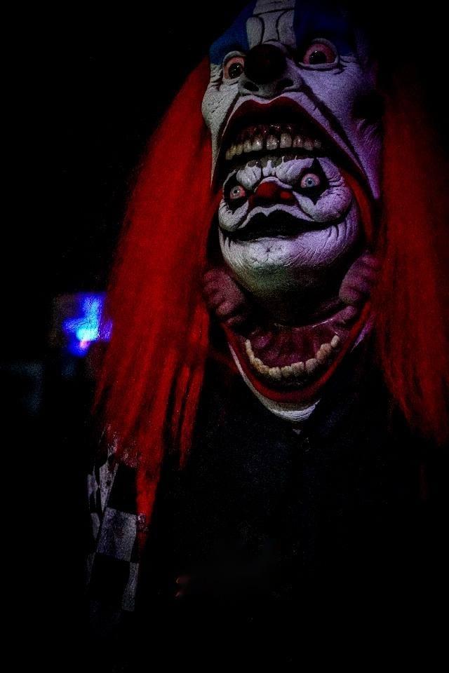 A red-haired clown character in close-up