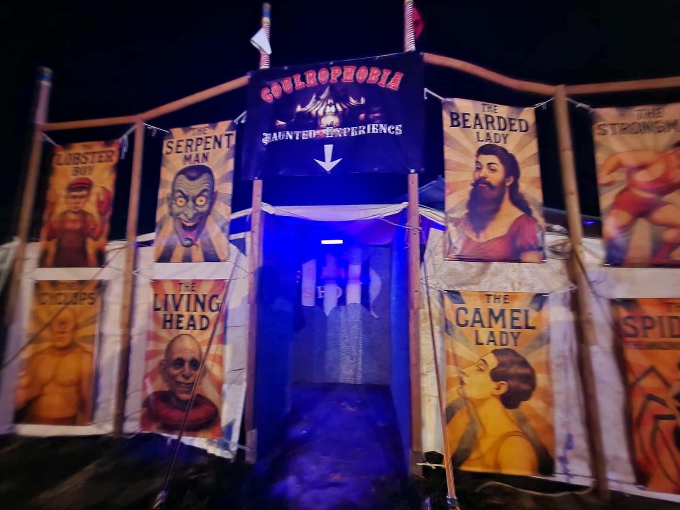 The real Coulrophobia haunted experience entrance, lined with vintage sideshow banners