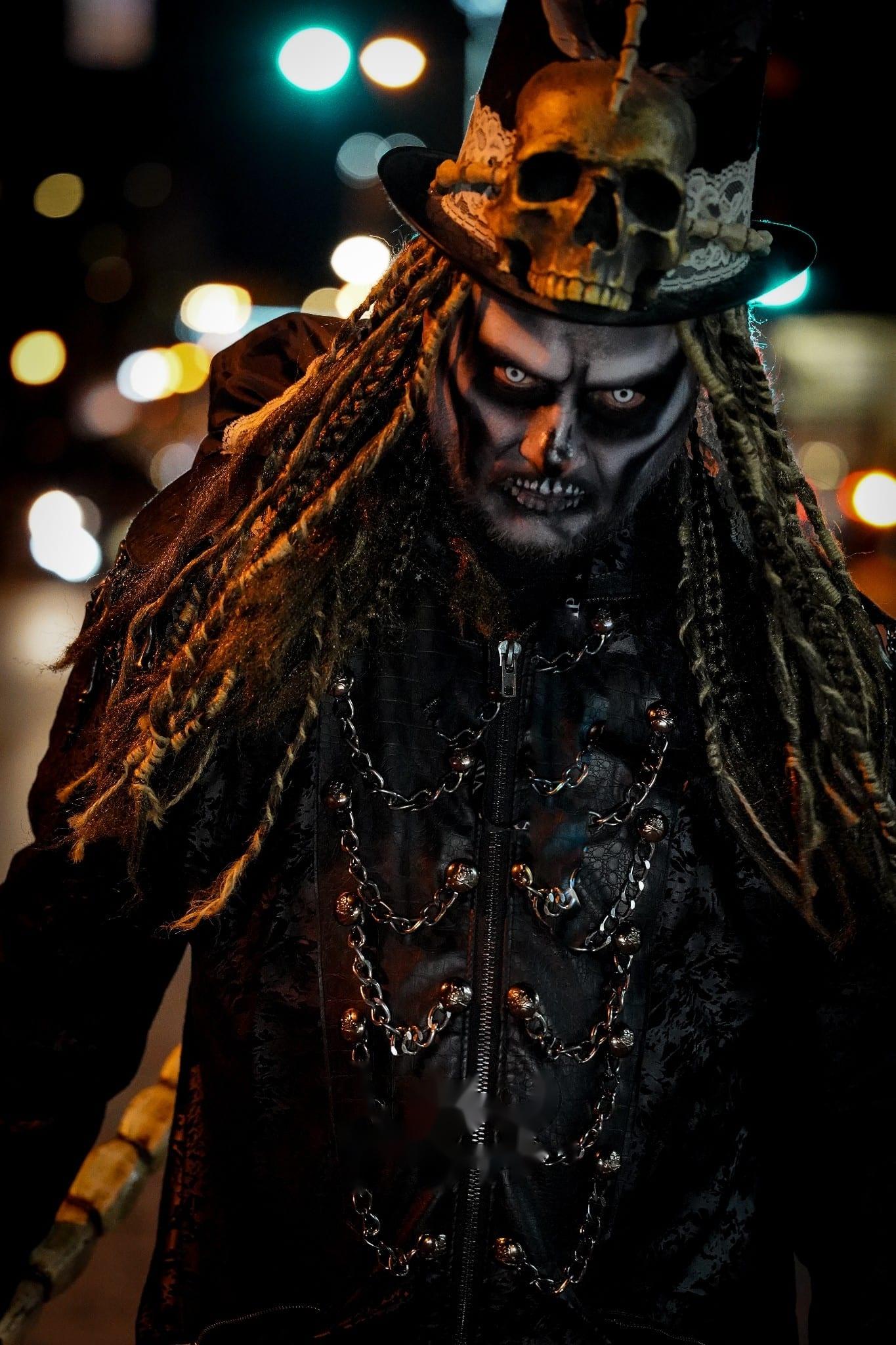 A top-hatted character under warm firelight